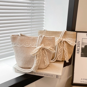 Summer straw tote bag with elegant lace bow and woven rope handles for beach vacation