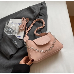Detail of light pink matte small square bag with decorative silver metal flower chain
