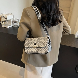 Minimalist black and white jacquard square crossbody bag with textured wave pattern