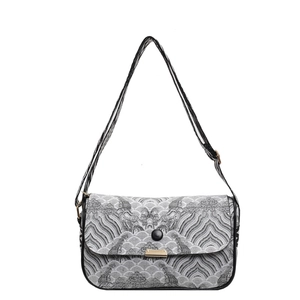 Minimalist black and white crossbody bag with traditional wave pattern and thin strap