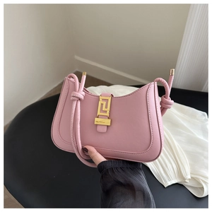 Detail of pink hobo bag with textured leather, knotted strap and gold buckle