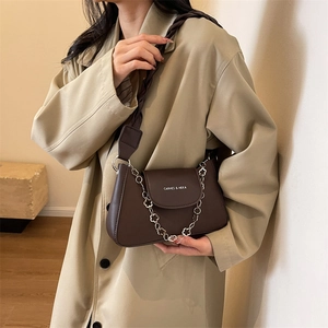 Retro dark brown crossbody bag with silver floral chain and woven strap for elegant commute