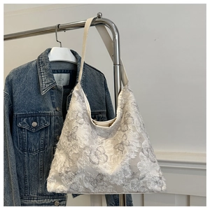 Detailed 3D butterfly embroidery with fringe tassels on a white canvas tote bag