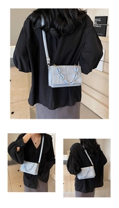Detailed views of light blue crossbody bag with square quilted texture and acrylic chain