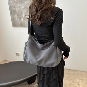 Minimalist large capacity dark grey crossbody messenger bag shown on model for daily use