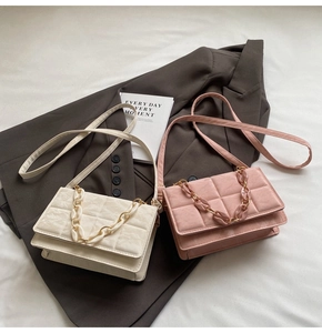Detailed view of quilted faux leather bags in beige and pink with stylish chain handles