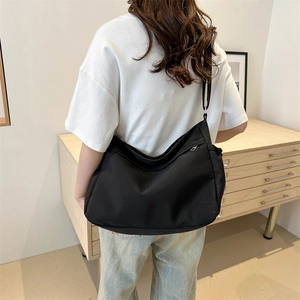 Minimalist black large capacity canvas crossbody bag with adjustable wide strap for daily use