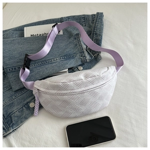 Detail of white woven sling bag featuring purple nylon strap and plastic buckle