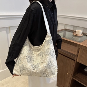 Chic beige canvas tote with butterfly prints and fringe detail, minimalist shoulder bag