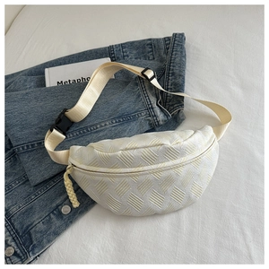 Macro shot of white woven lattice texture and adjustable strap on crescent waist bag