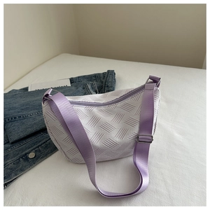 Detail of white geometric textured crescent bag with light purple nylon shoulder strap