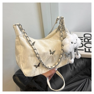 Détail du sac demi-lune blanc avec papillons argentés et pendentif nuage pelucheux