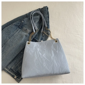 Detailaufnahme der hellblauen Shopper-Tasche mit Faltenoptik und goldener Kette