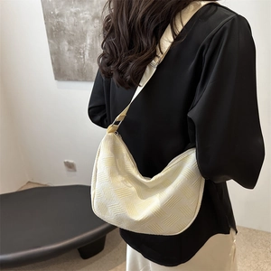 Chic beige half-moon tote bag with geometric relief texture and adjustable shoulder strap
