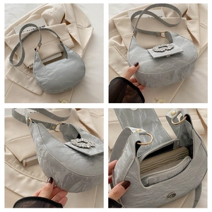 Macro shot of grey hobo bag with marble embossing and sparkling rhinestone buckle