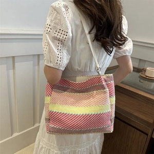 Sac à bandoulière tissé à rayures colorées pour les vacances d'été sur un mannequin