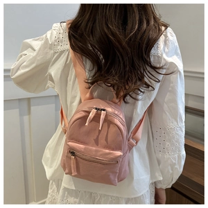 Pink nylon mini backpack for women showing size perspective on a model's back