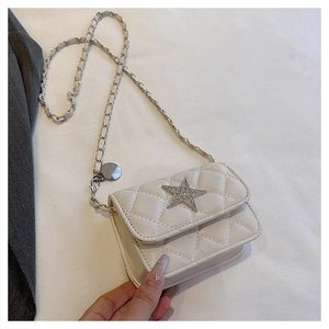 Detail of white quilted crossbody bag with sparkling star buckle and chain strap