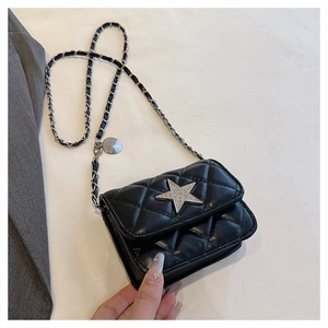 Detail of black quilted leather shoulder bag with silver star crystal and chain strap