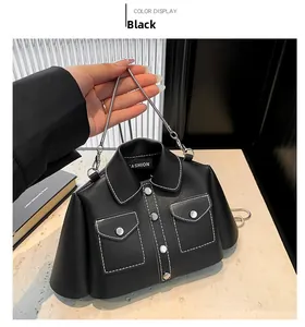Detail of creative jacket-shaped black crossbody bag with white stitching and metal chain
