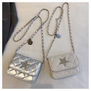 Detail of silver and beige quilted mini bags with star rhinestone buckles and metal chains