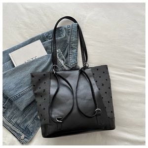 Detail of multi-functional tote bag with polka dot pattern and black bow embroidery