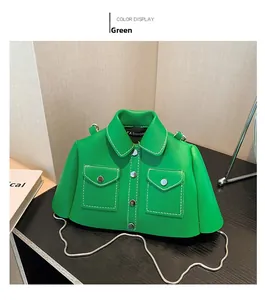 Detailed view of creative green jacket-shaped crossbody bag with white stitching and chain