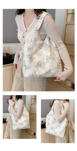 Detail of white lace tote bag featuring intricate grey butterfly embroidery and spacious design