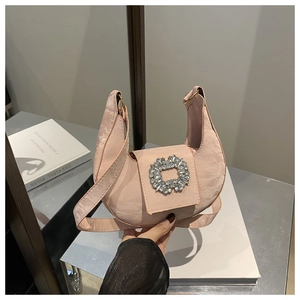 Detailed shot of pink pleated hobo bag with a luxury crystal floral buckle and soft texture