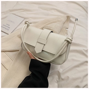 Detail of ivory PU leather handbag with horizontal texture and knotted shoulder strap