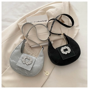 Detail view of crescent hobo bags with sparkling rhinestone buckles and pleated texture