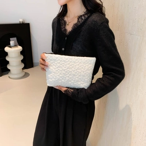 Minimalist white quilted clutch bag with unique 3D bubble texture and spacious design
