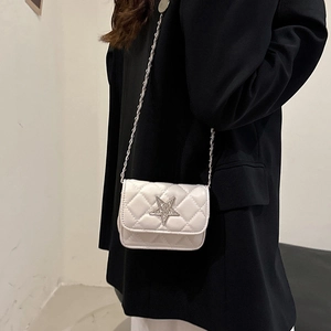 White quilted crossbody mini bag with star stud and silver chain shown on model