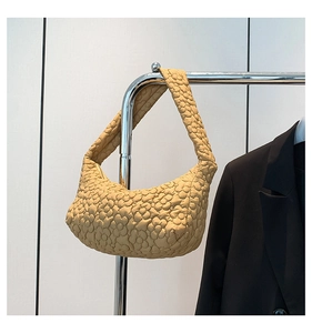 Détail du sac hobo jaune moutarde avec texture florale 3D matelassée sur tissu léger
