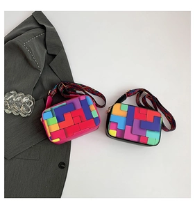 Detail of colorful geometric patchwork square bags with stylish wide woven shoulder straps