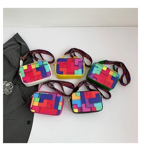 Close-up of five color-block crossbody bags with pixel art patterns and wide straps