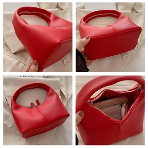 Detail view of red PU leather hobo bag showing interior space and silver zipper closure