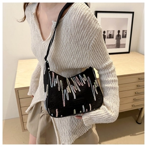 Detail of black nylon shoulder bag with colorful wave embroidery and wide strap