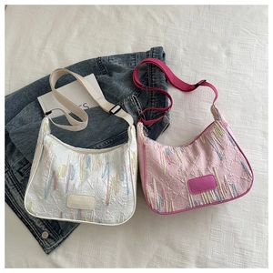 Detail of nylon shoulder bags with diamond quilting and adjustable fabric straps