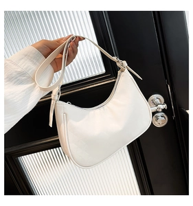 Detail of white hobo bag with subtle plaid texture and silver metal hardware