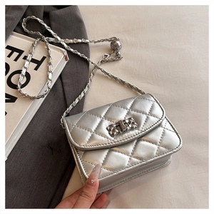 Detail of silver quilted leather bag with metallic chain strap and ball buckle