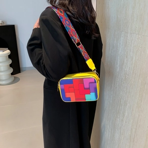 Vibrant yellow crossbody bag with geometric tetris print and wide ethnic fabric strap