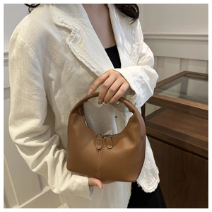 Brown leather crescent handbag with stylish vertical stitching and dual zipper detail