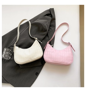 Detail view of cream and pink faux leather shoulder bags with quilted diamond pattern