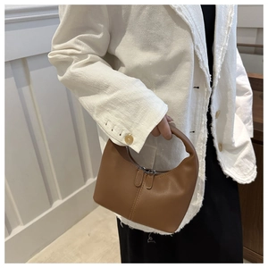 Chic brown crescent leather handbag with double zipper and decorative stitching detail