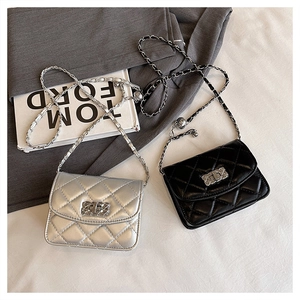 Detail of mini quilted chain bags in silver and black with elegant metal turn-lock closures
