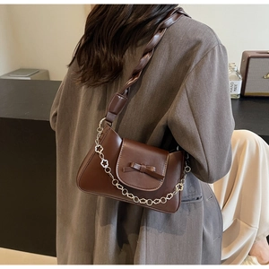 Brown PU leather shoulder bag featuring a stylish bow and flower chain strap detail