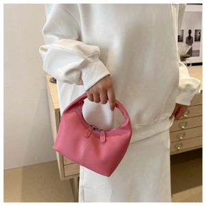 Detailed view of a soft pink mini hobo bag featuring a smooth PU leather finish and top handle