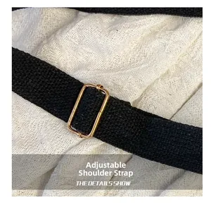 Detail of adjustable black canvas strap with premium gold metal rectangular buckle