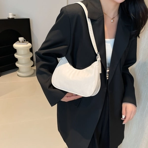 Chic beige hobo shoulder bag in premium textured leather for a stylish modern commuter look